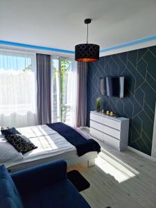A bed or beds in a room at Apartament Golden Loft Studio Mielno - 100m od plaży