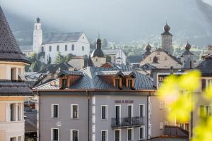 a view of a city with buildings and churches at Hotel De Londres in Brig