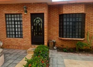 a brick house with a black door and windows at casita de lola in Ciudad Valles