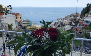 a bouquet of flowers sitting on a balcony at Villa Celentano in Positano