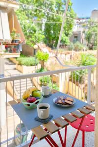 een tafel met een fruitschaal en een kopje koffie bij Venias Two-Bedroom apartment Kallimarmaro and Zappeio area in Athene