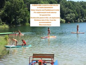 a group of people on paddle boards in the water at BIVIO apartment Dolná in Banská Štiavnica