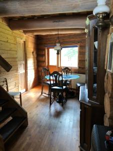 a dining room with a table in a log cabin at Villa Hideaway in Pärnu