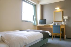 Postel nebo postele na pokoji v ubytování Hotel Abest Kochi