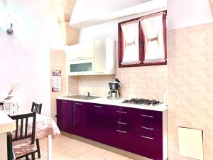 a kitchen with a sink and a stove at LA PICCOLA DIMORA in Carovigno +16 photos
