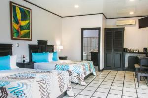 Ένα ή περισσότερα κρεβάτια σε δωμάτιο στο Arenal Manoa Resort & Hot Springs