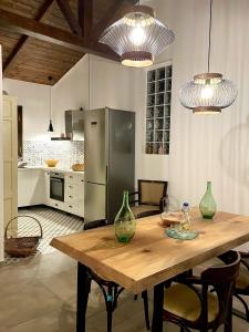 a kitchen with a wooden table with vases on it at Katikies Savrani in Perivólia