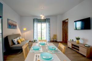 a living room with a table and a couch at Thèros garden in Istro