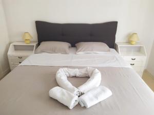 a bed with two towels in the shape of a heart at Braavos Apartment 2 - Šibenik city center in Šibenik