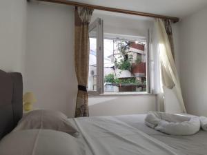 a bed in a room with a window at Braavos Apartment 2 - Šibenik city center in Šibenik