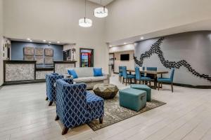 a lobby with a couch and chairs and a table at Best Western Huntsville in Huntsville