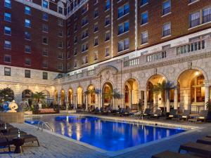 a swimming pool in the courtyard of a building at The Royal Sonesta Chase Park Plaza St Louis in Saint Louis