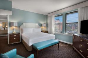a hotel room with a bed and a television at The Royal Sonesta Chase Park Plaza St Louis in Saint Louis