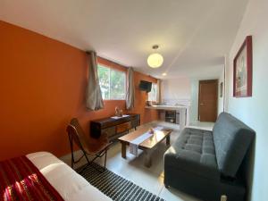 a room with a bed and a couch and a table at Cozy Apartment close to Andares @serra in Guadalajara