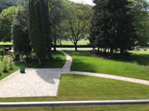 a path through a park with trees and grass at Rieslingresidenz in Traben-Trarbach