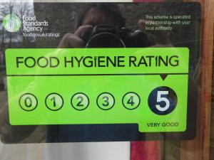 a sign on a glass door with a food hygiene rating at Clerk Laithe Lodge in Newton