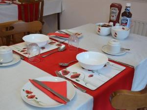 a table with plates and bowls and chopsticks on it at Glendale Bed and Breakfast, Cushendall in Cushendall