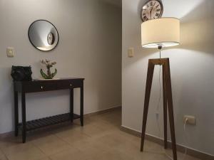 a room with a table and a lamp and a clock at Marfil in Posadas