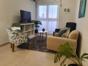 a living room with a couch and a tv at Marfil in Posadas