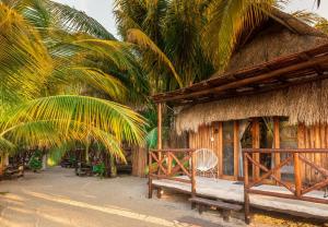a hut with a bench in front of it at Eco Cabañas Laak Holbox - Adults Only - Self Check In in Holbox Island