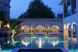 a swimming pool in a courtyard at night at Samode Haveli in Jaipur