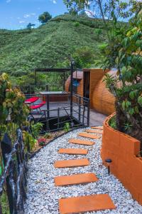 a stone path leading to a house with a hill at Glamping The Mountain in Guatapé
