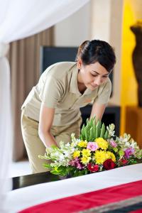 a woman is looking at a bouquet of flowers at Villa Zanissa in Seminyak +54 photos