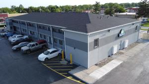 an overhead view of a building with cars parked in a parking lot at Days Inn by Wyndham Indianapolis East Post Road in Indianapolis
