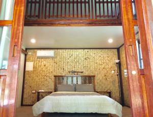 a bedroom with a large bed in a building at Babaland in New Agutaya