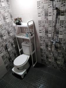 a bathroom with a toilet and a shower at Family Villa C37 Batu in Batu
