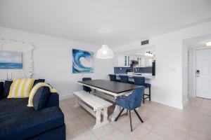 a living room with a dining room table and a couch at Ocean Village Club O35 in Saint Augustine +48 photos