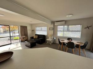 a living room with a couch and a table and chairs at Flat Rock in Lake Tekapo