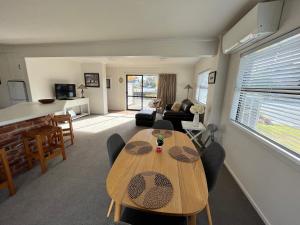 a living room with a table and chairs and a couch at Flat Rock in Lake Tekapo