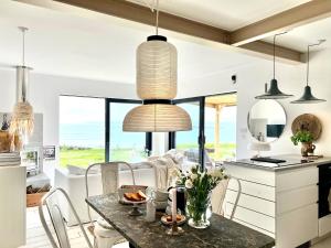 a kitchen and dining room with a table and chairs at The Tidal Shore - Adults Only - in Marazion