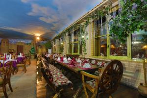 a restaurant with tables and chairs with christmas decorations at Asia Grand Hotel in Dushanbe