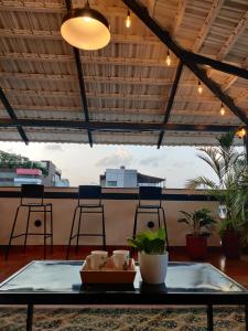 a table with plants on top of a patio at Olive Koramangala 100ft Road by Embassy Group in Bangalore