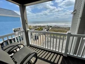 a porch with two chairs and a view of the beach at Cape Coddages II Condo in Myrtle Beach