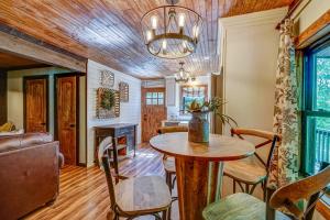 a living room with a table and chairs and a couch at Rustic Oasis in Ellijay