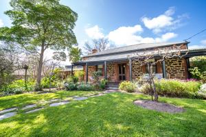 a brick house with a garden in front of it at Secret Garden - Luxury Cottage - Giant 85inch TV in McLaren Vale