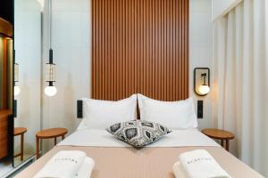 a hotel room with a bed with two towels at Acantha Suites in Skala Potamias