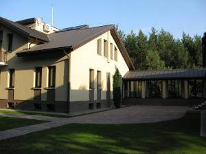 a white building with a black roof at Uzkanaves 15 in Palanga