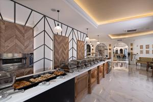 a buffet line in a hotel with a lot of food at Delfina Boutique Hotel in Georgioupolis