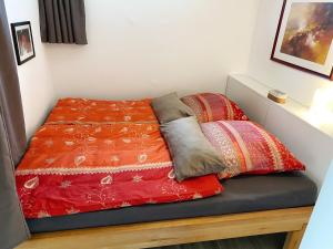 a bed with two pillows on top of it at Ferienwohnung An der Pferdsweide in Trier