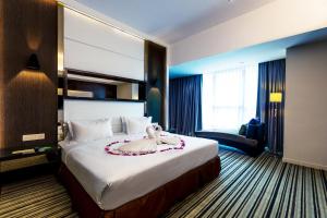Postel nebo postele na pokoji v ubytování Ixora Hotel Penang