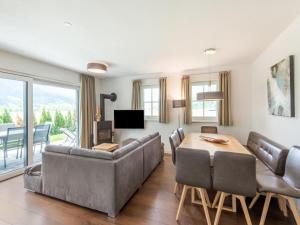 a living room with a couch and a table at Luxurious holiday home with sauna in Niedernsill Salzburgerland in Niedernsill