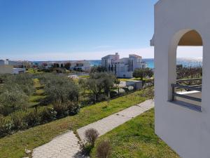 a view from the side of a white building with an open window at Skion Palace Beach Hotel-Bungalows & Boutique Hotel in Nea Skioni