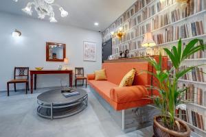 a living room with an orange couch and a table at Sliema Creek Suites in Sliema