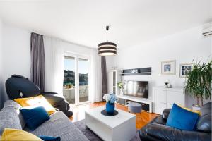 a living room with a couch and a table at Apartment Sunset free parking in Dubrovnik
