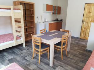 - une cuisine et une salle à manger avec une table et des chaises dans l'établissement Autocamp Slunce Žandov, à Žandov