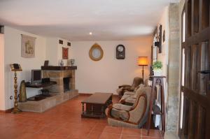 a living room with a couch and a fireplace at Casa Rural El Cartero in Santa Lecina